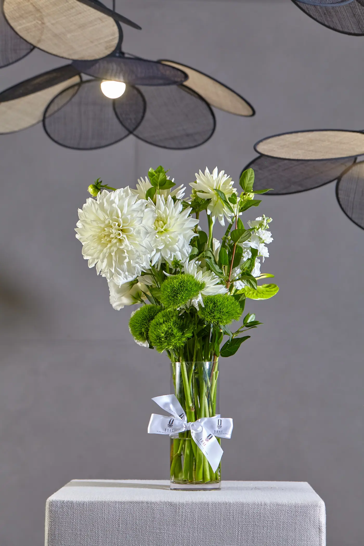 White dahlias and stock in a glass vase, photographed in the YDAL studio in Bedfordview
